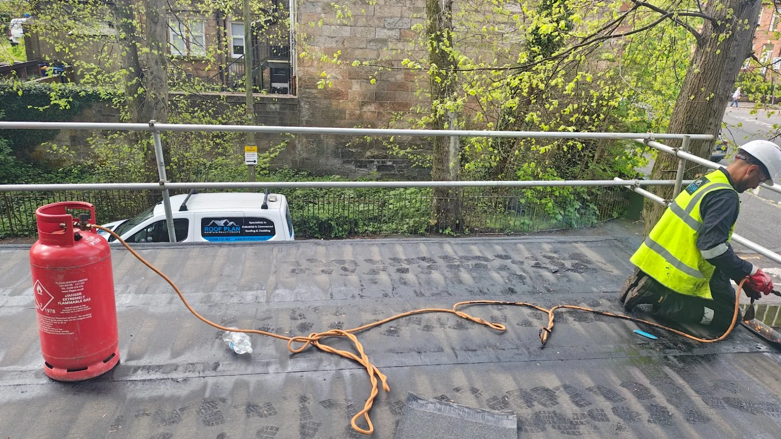 Roof Plan van beside a gas cylinder and torch-on felt roofing